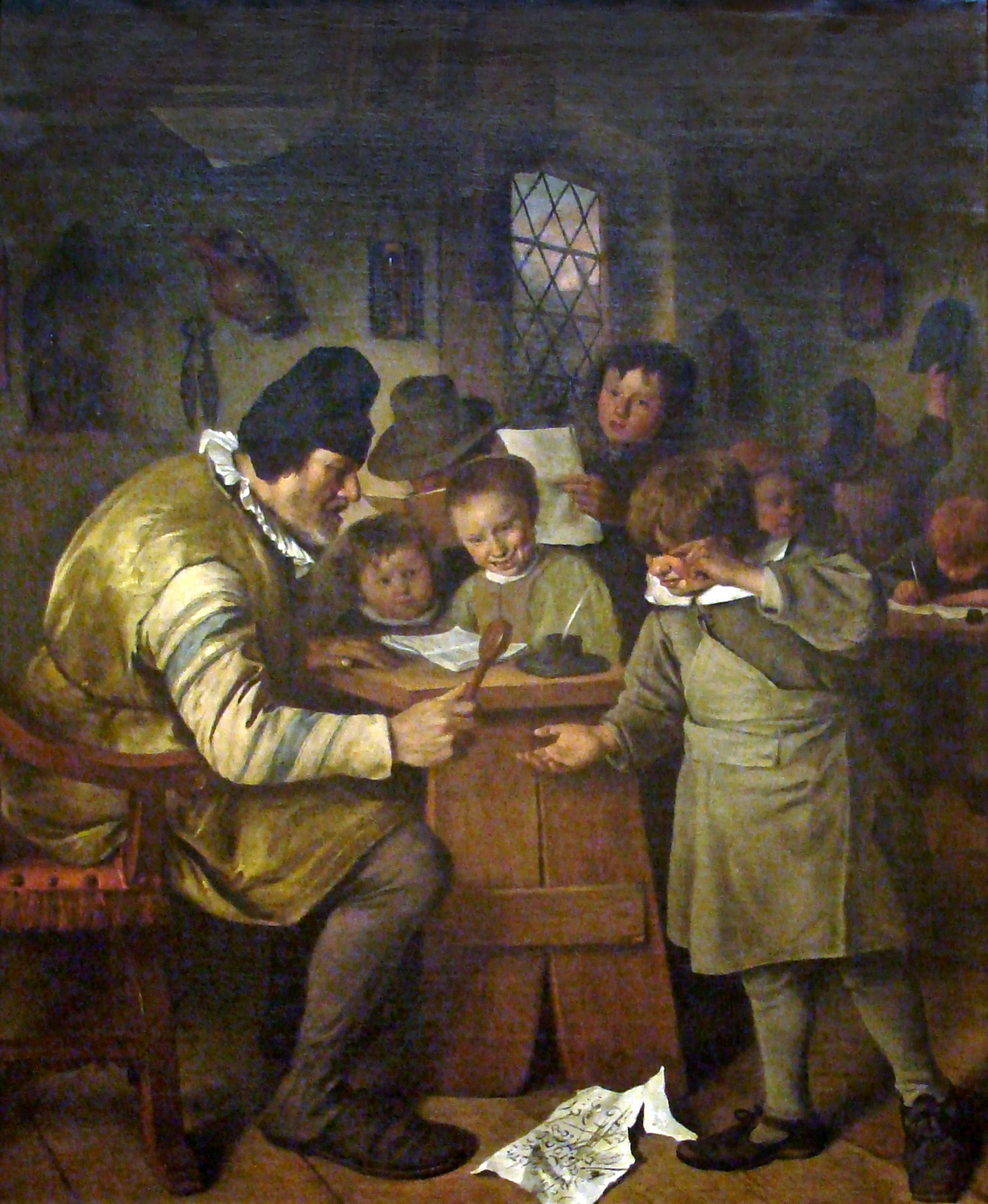 Kind krijgt tik op de hand met de plak (schilderij van Jan Steen (1625/1626-1679), geschilderd circa 1663/1665. Titel: de dorpsschool; olieverf op doek. Bron: Nationale Galerie van Ierland. Licentie: Publiek Domein.